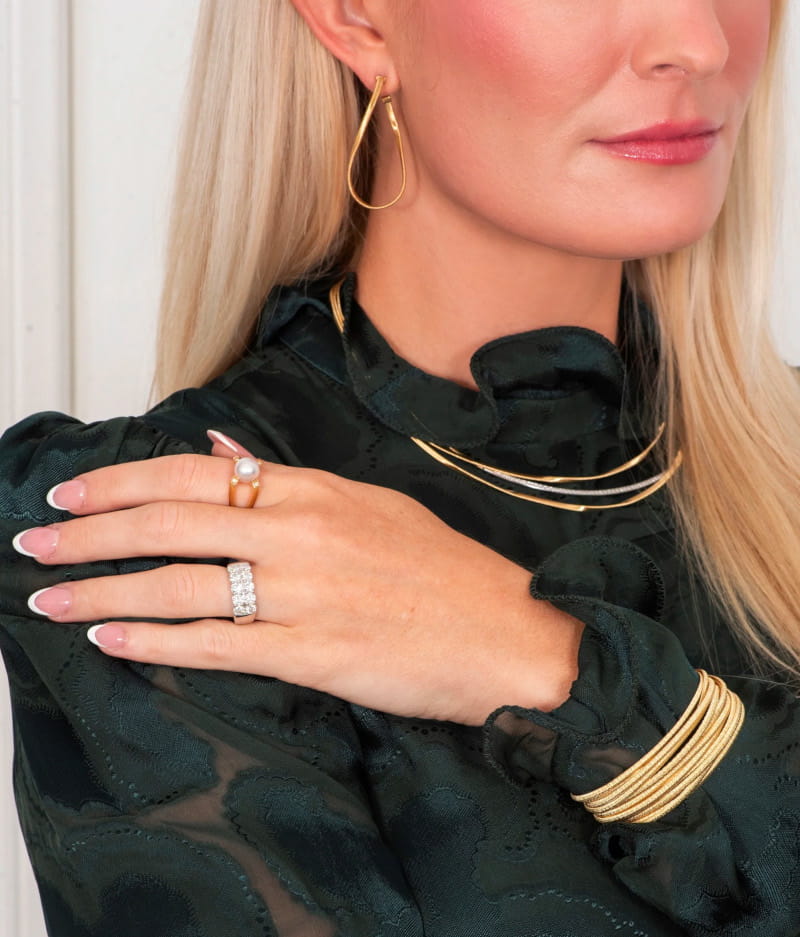 Model Wearing Gold Bracelets and Necklaces